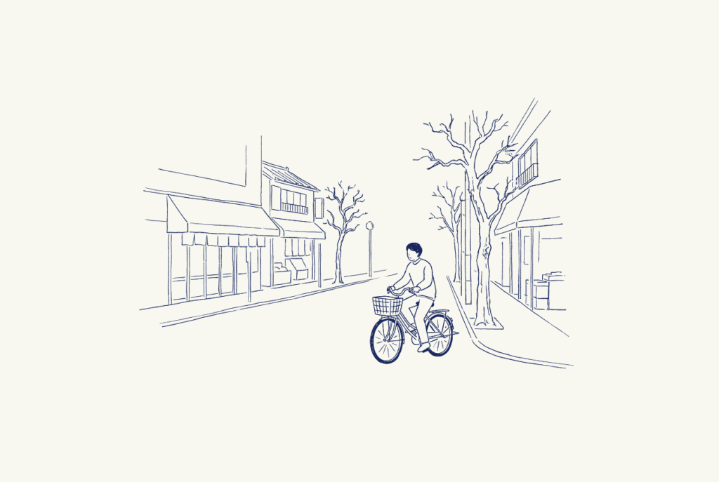 朝の商店街を自転車で走る人の線画イラスト
